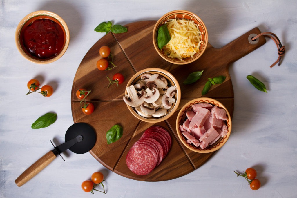 Pizza toppings on a table