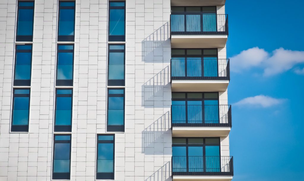 the-tinted-windows-of-a-gray-building-scaled