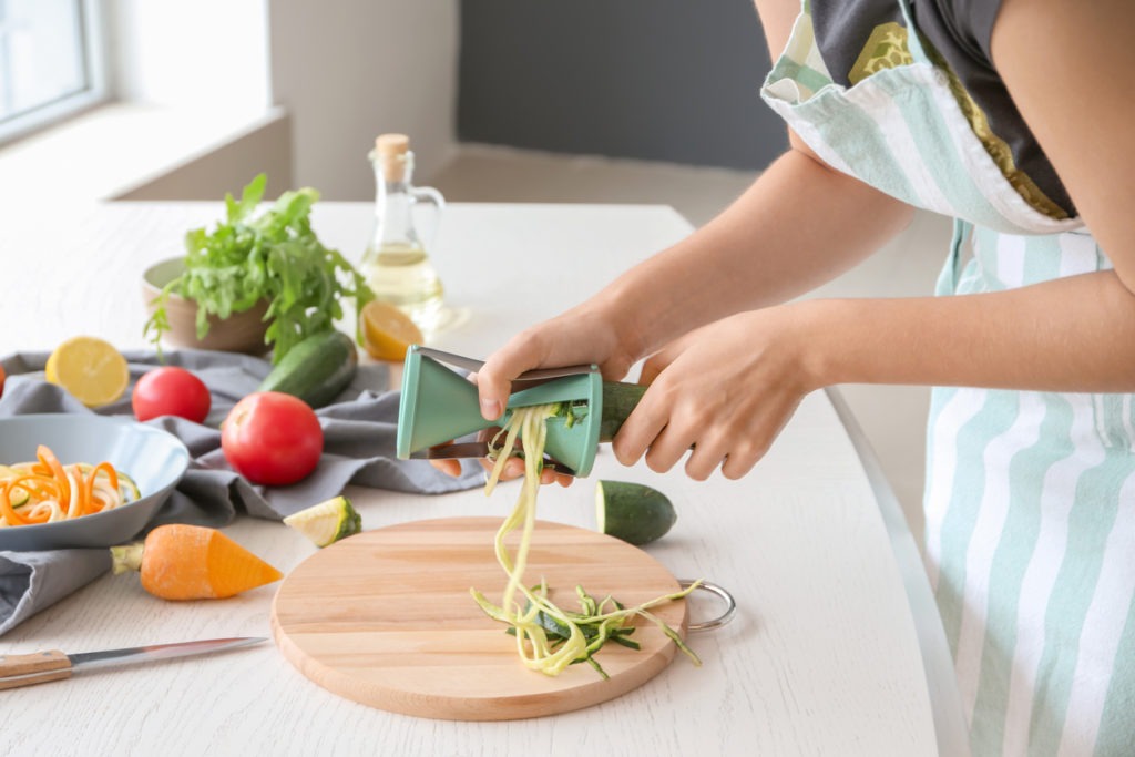 Woman making zucchini spaghetti
