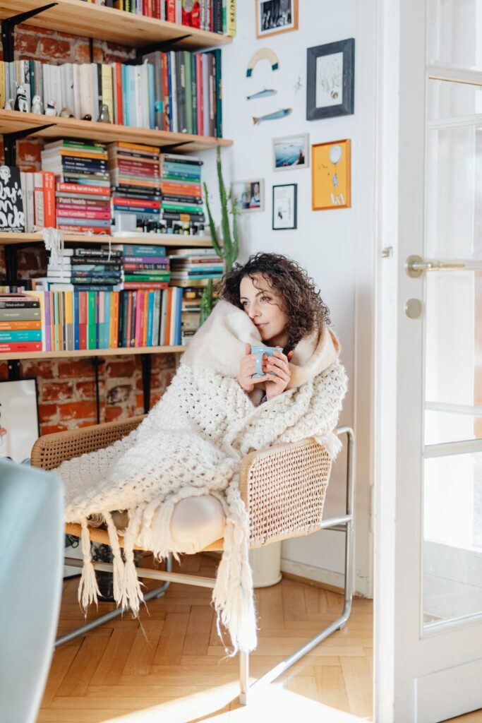 a woman wrapped in cozy blanket