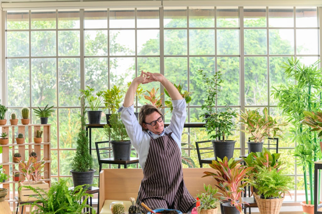 man stretching in his garden
