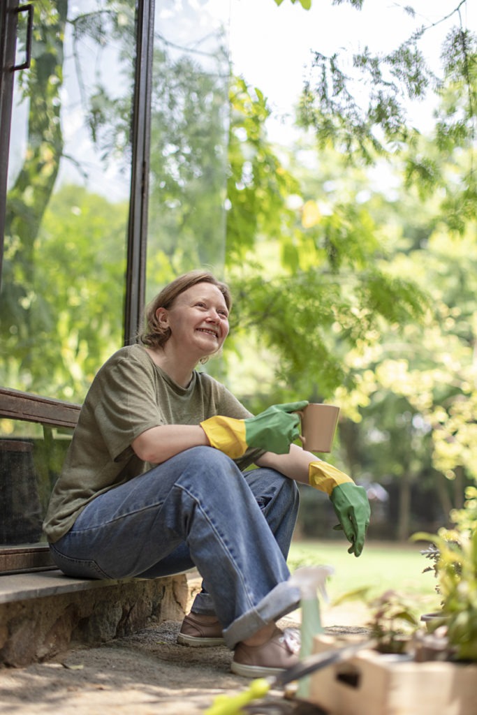 woman holding a cup in her garden