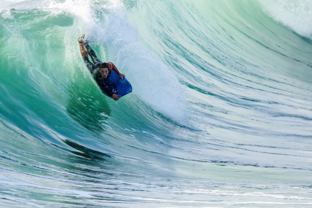 Bodyboarder in action on the ocean waves on a sunny day