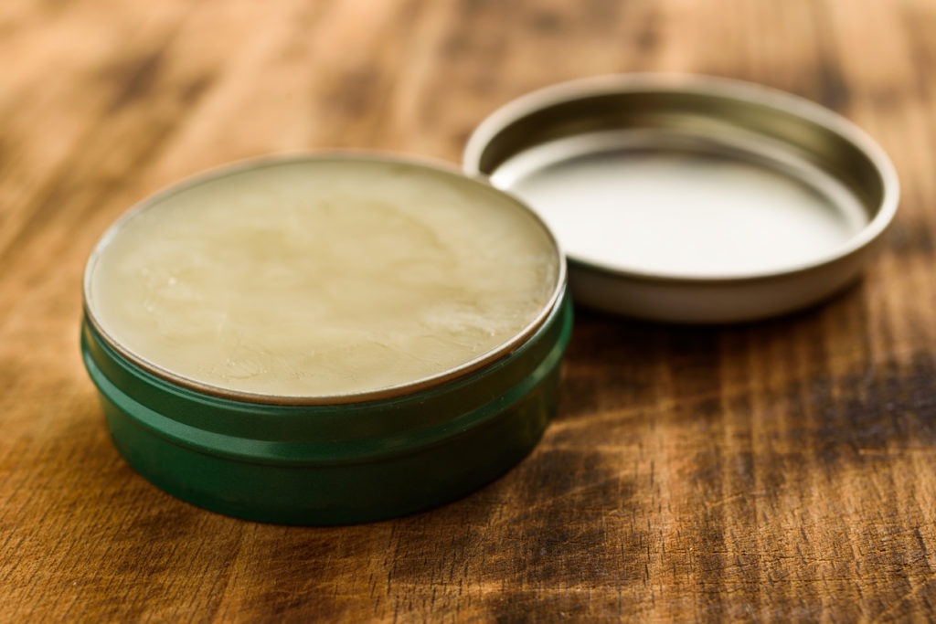 alm in a tin can on a wooden table