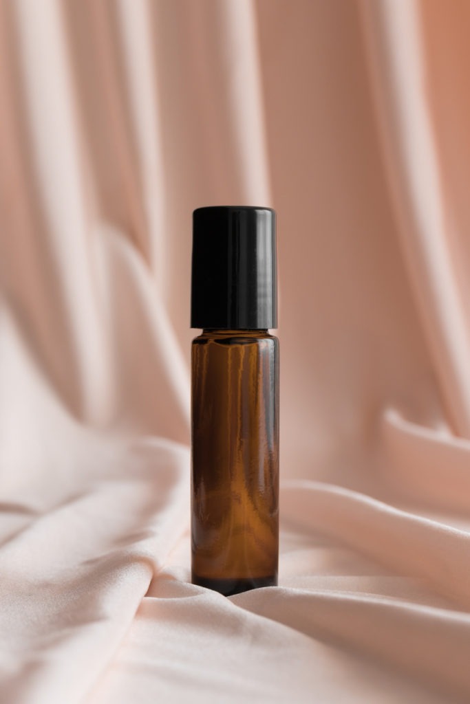 roll on bottle in a soft pink background