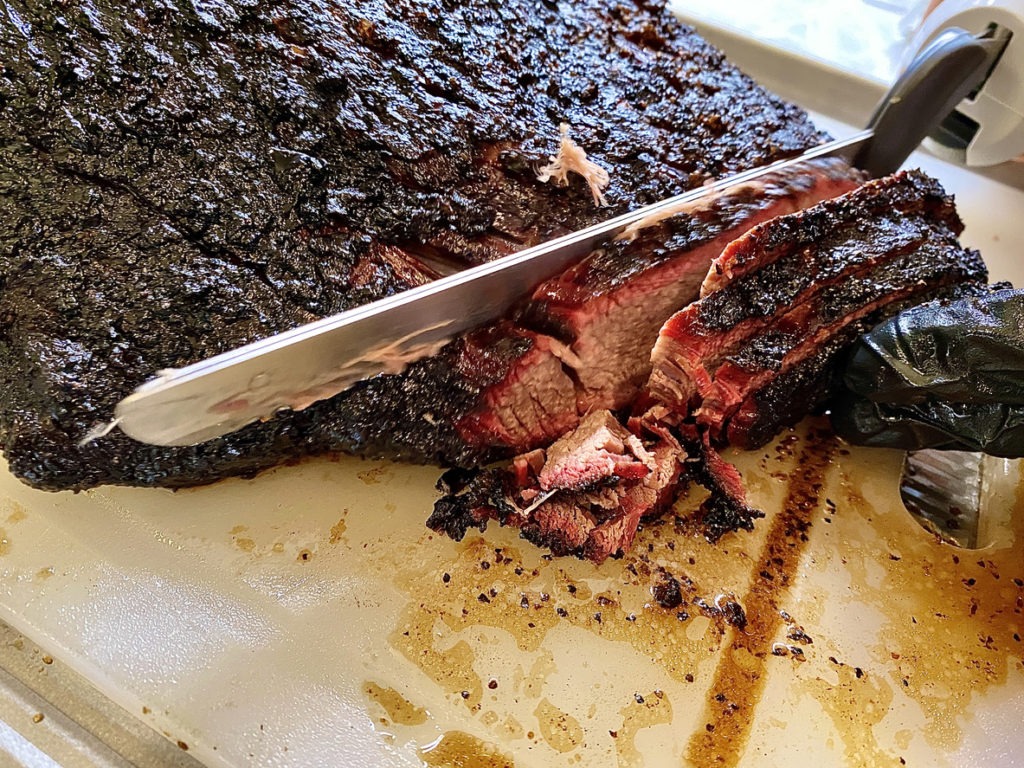 alt tag electric knife slicing through brisket