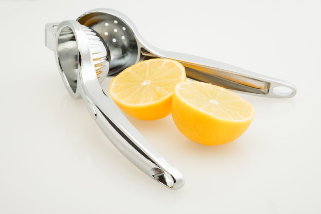 Cut out of a lemon press alongside a lemon cut in half