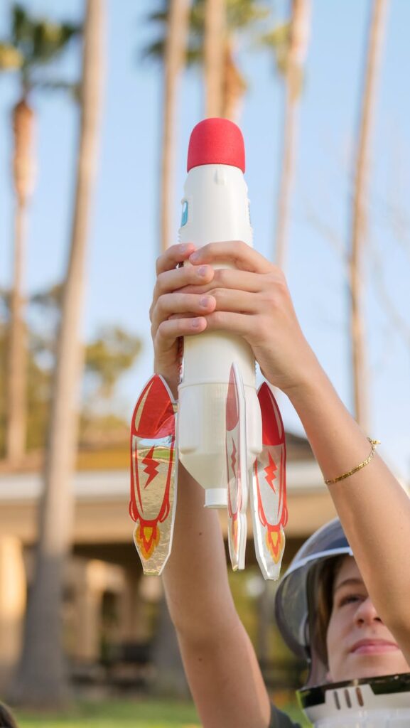 a boy holding his toy rocket