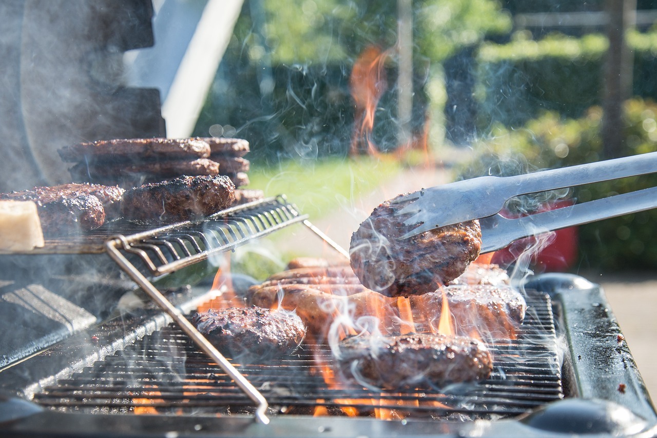 cooking hamburger patties on a grill