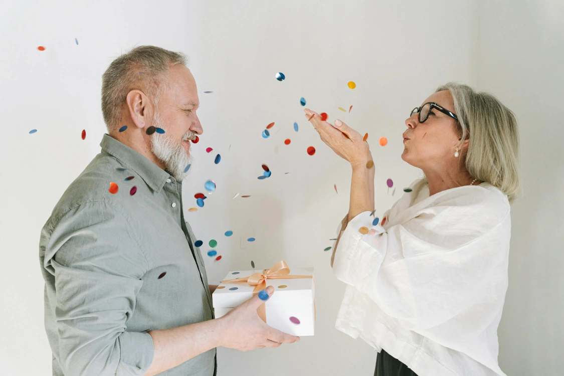 A man receiving gift from wife