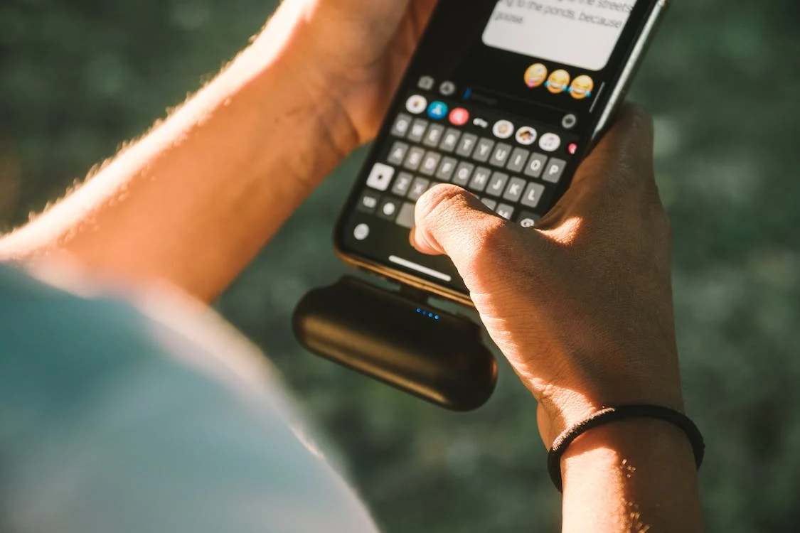 A phone connected to a portable charger or power bank