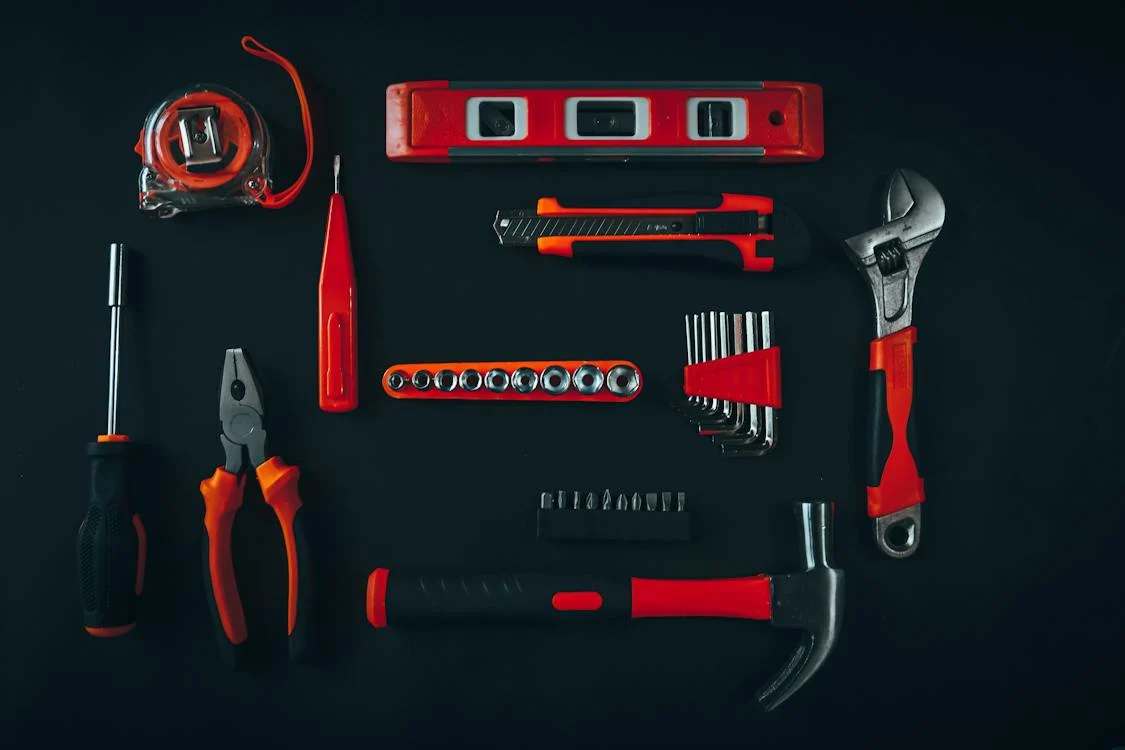 A set of assorted tools on a black surface