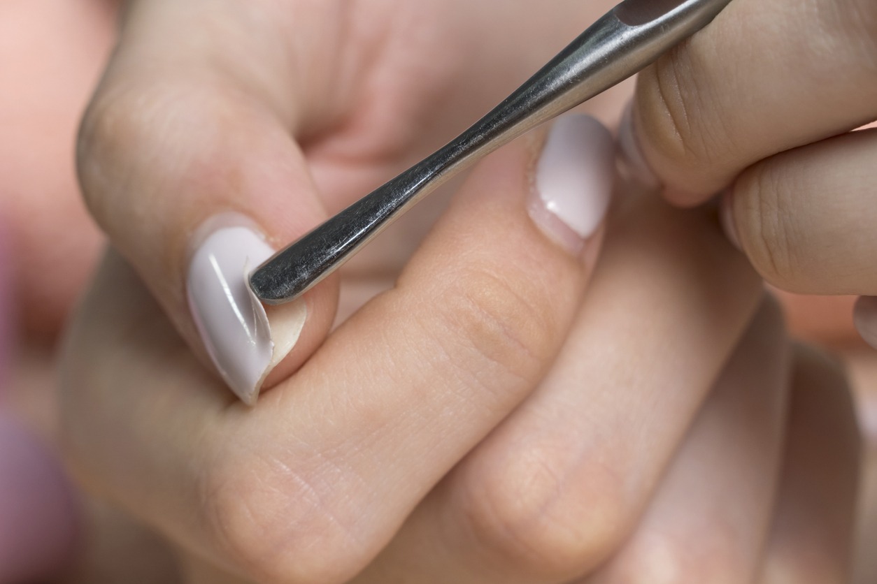 Remove the gel polish with a metal pusher