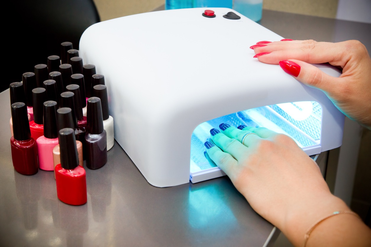 Woman getting professional manicure in beauty salon