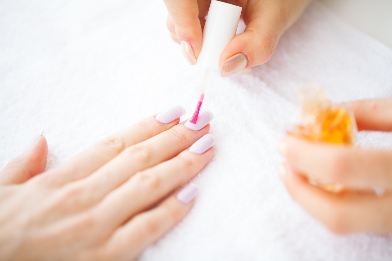 Manicure Master Applying Nail Polish in Beauty Salon