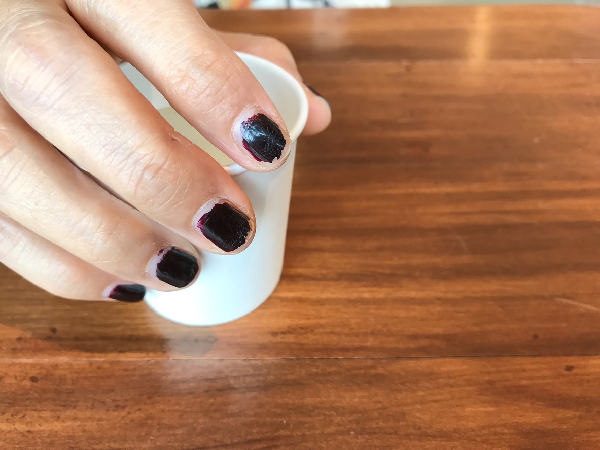 Woman's hand holding cup of water