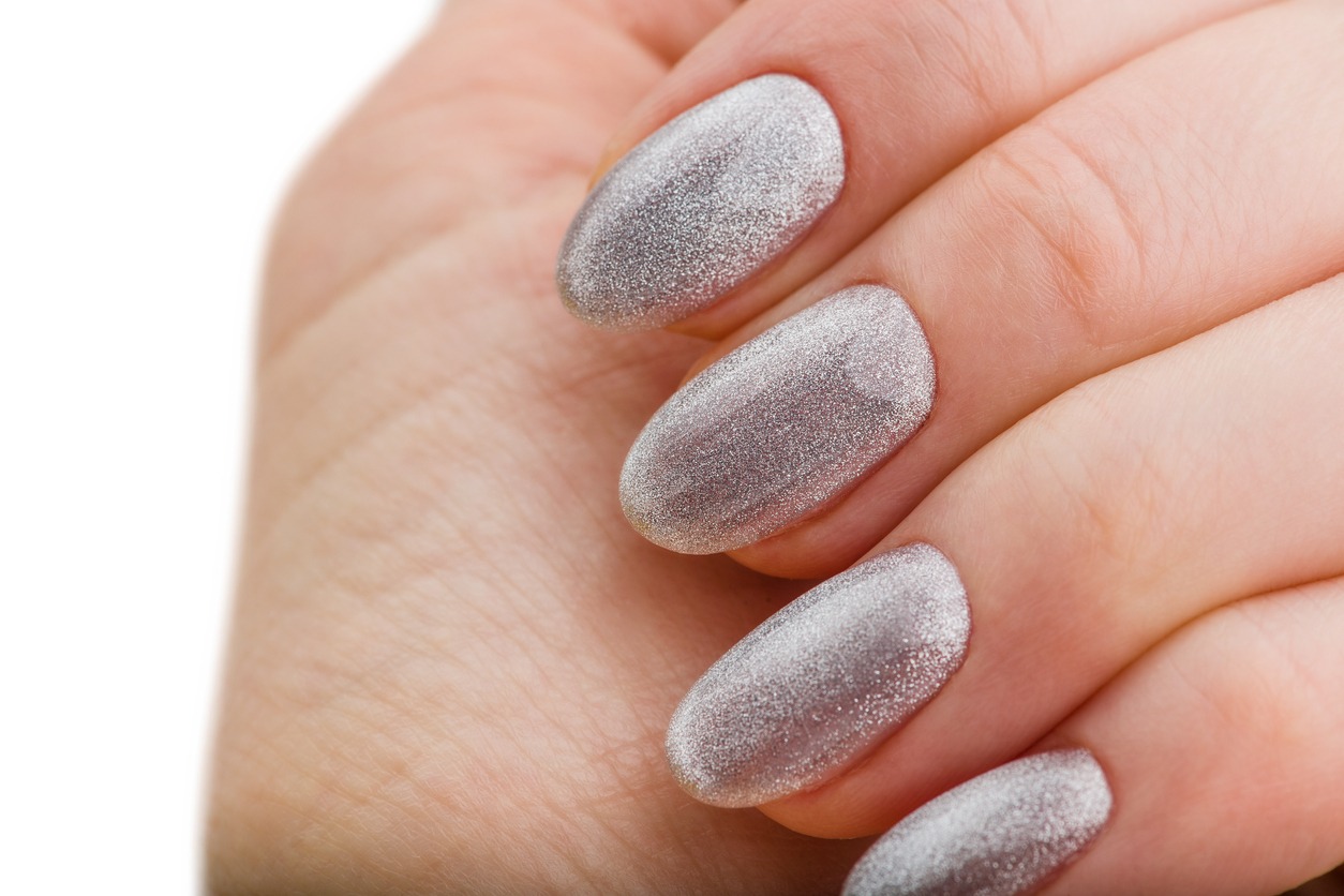Hands With Bright Silver Christmas Manicure