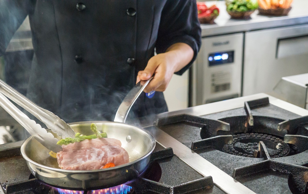 a meal being prepared on an industrial gas stove