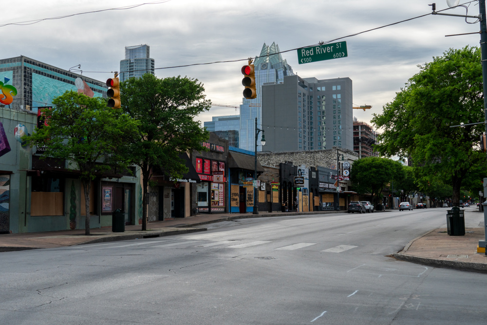View of multiple closed bars in Downtown Austin from the corner of 6th Street and Red River St