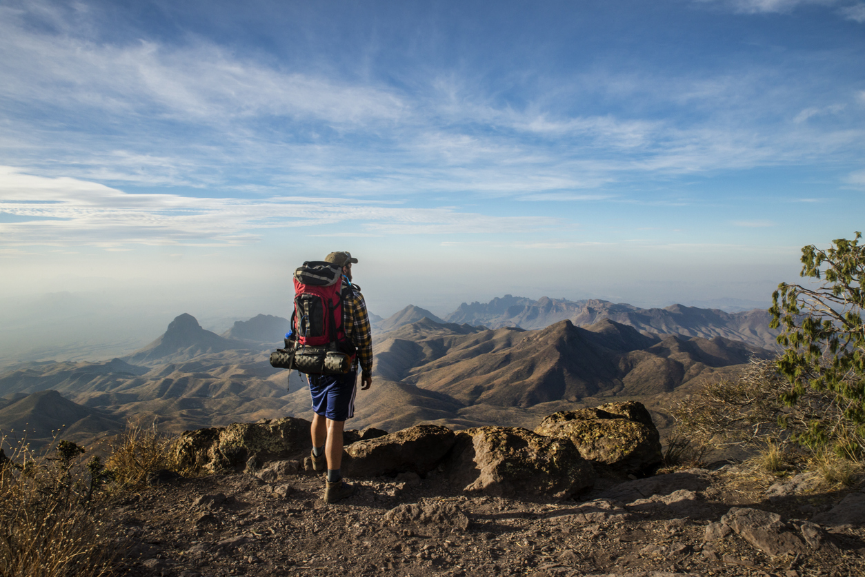 a hiker standing on a cliff