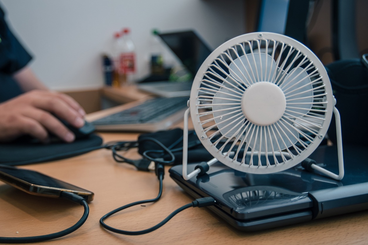 a portable battery-powered fan on a table