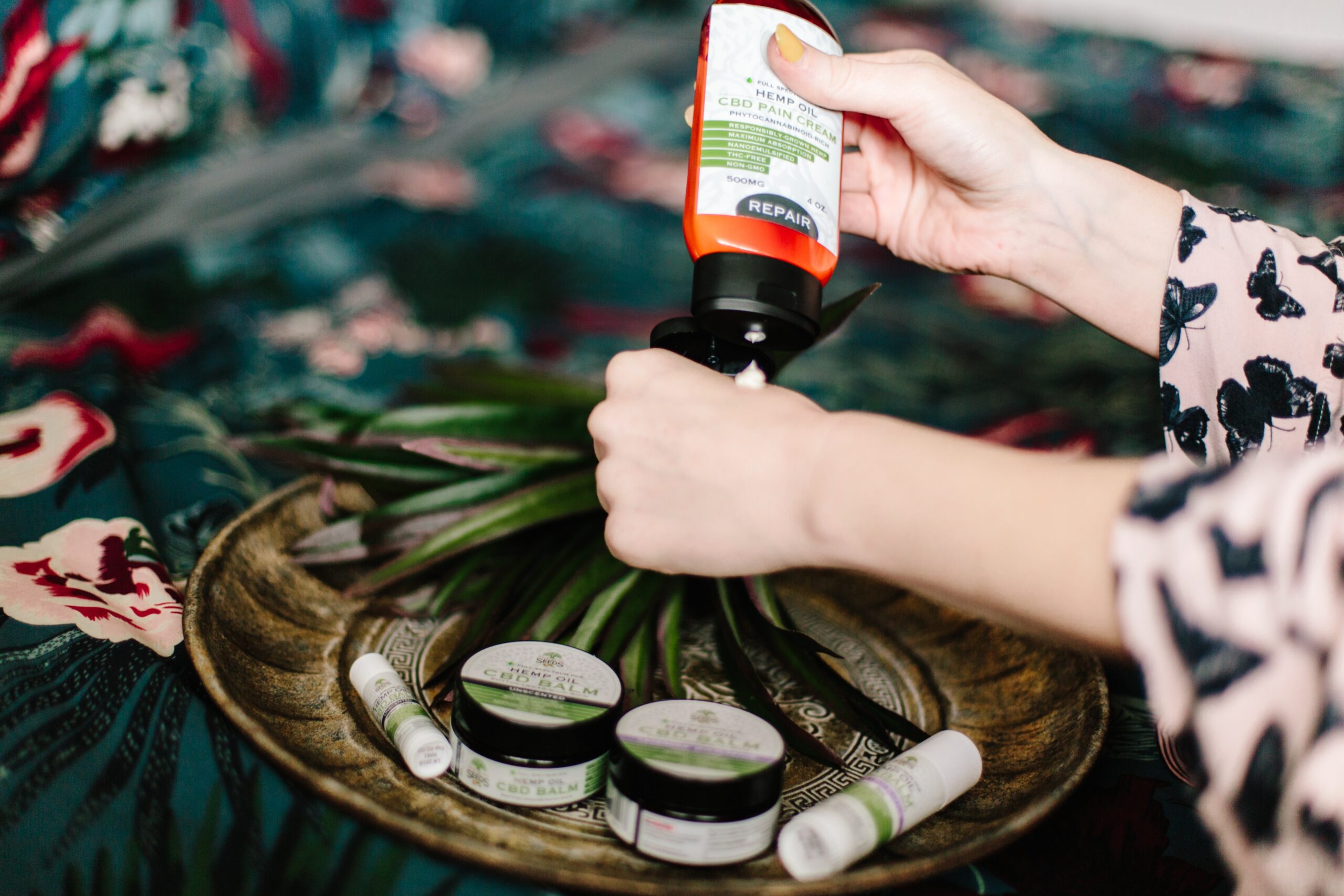 a woman putting some lotion on her hand