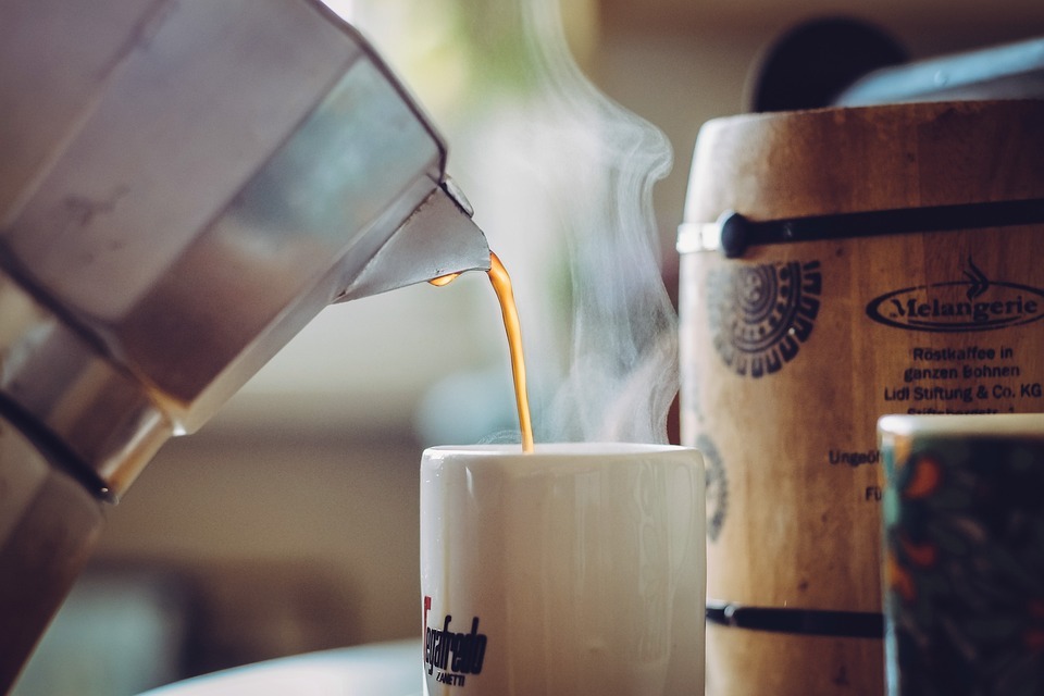 A drink being poured in a cup