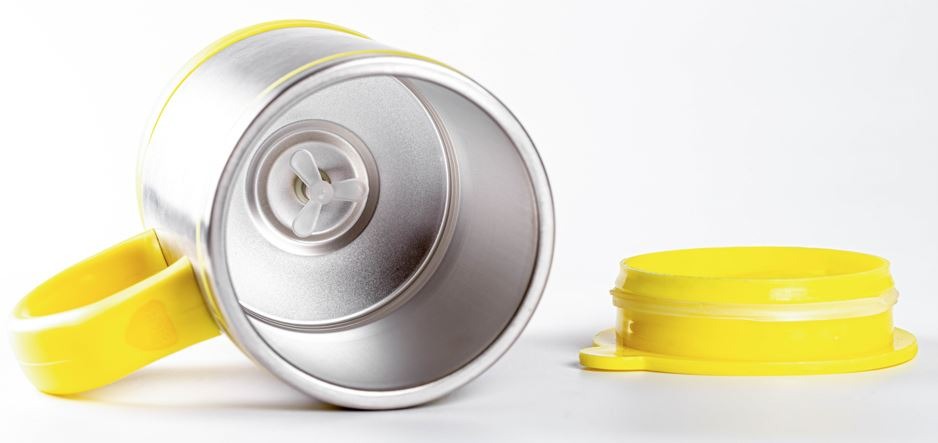Empty metal mug mixer with yellow lid