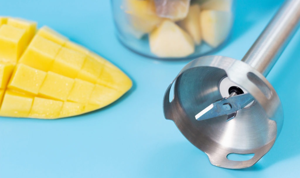 A closeup of an immersion blender’s blade