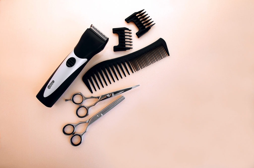 Barber tools on a peach surface.