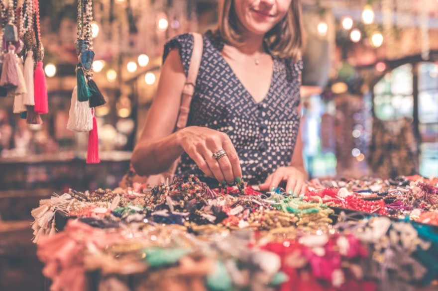 woman selecting beaded jewelry