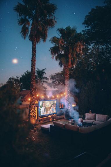 palm trees near projection screen during nighttime