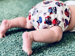 crawling baby wearing a cloth diaper