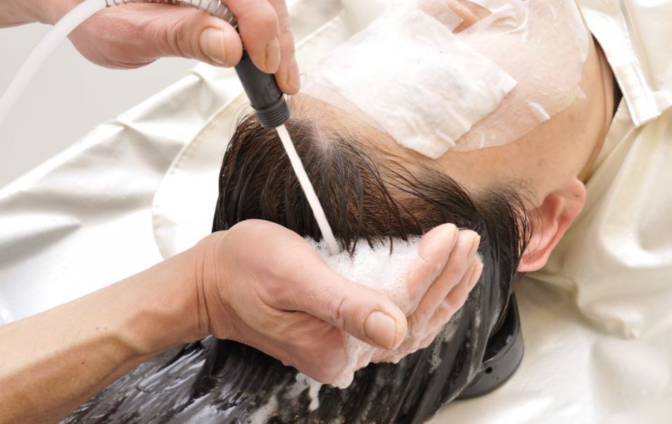 A woman getting a hair spa treatment