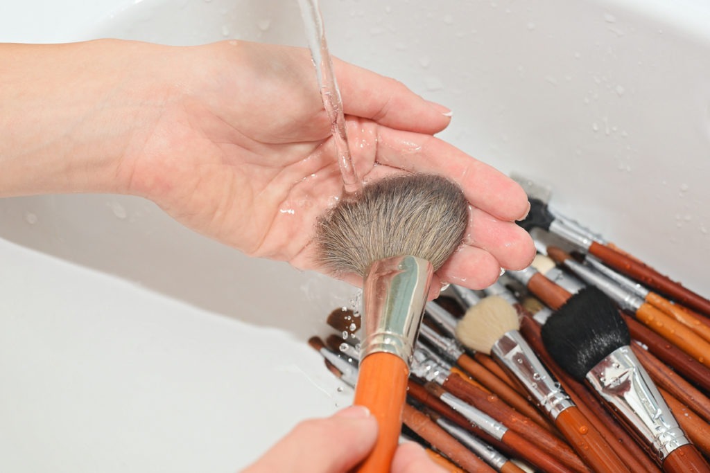 washed brushes under running water