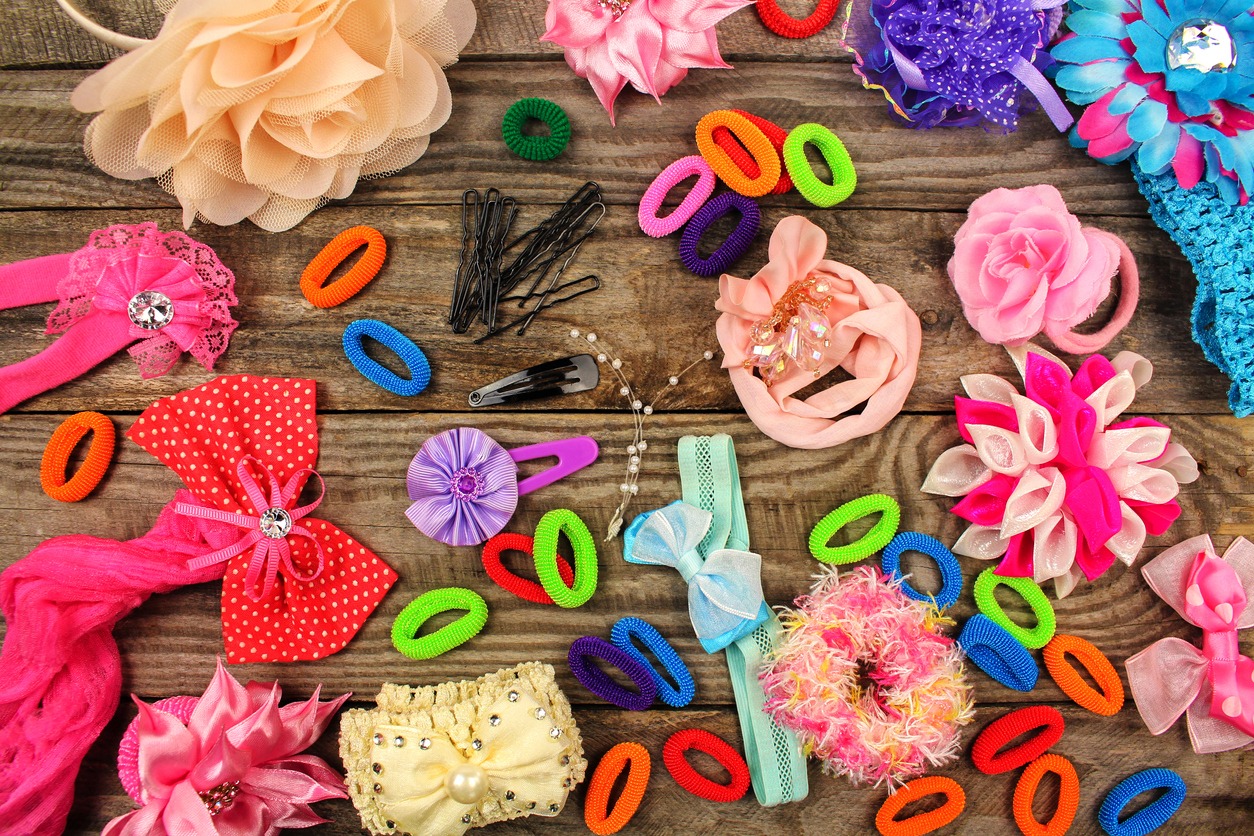 Different hair clips on wooden background
