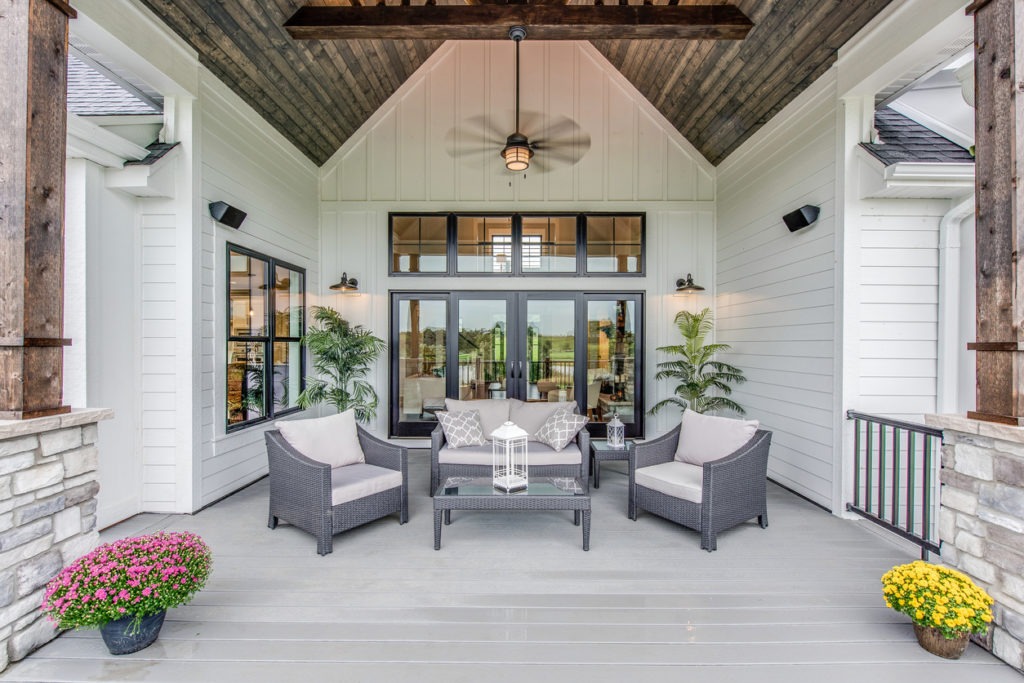 an outdoor living space with a ceiling fan