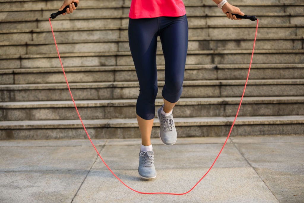 Woman exercising using jumping rope