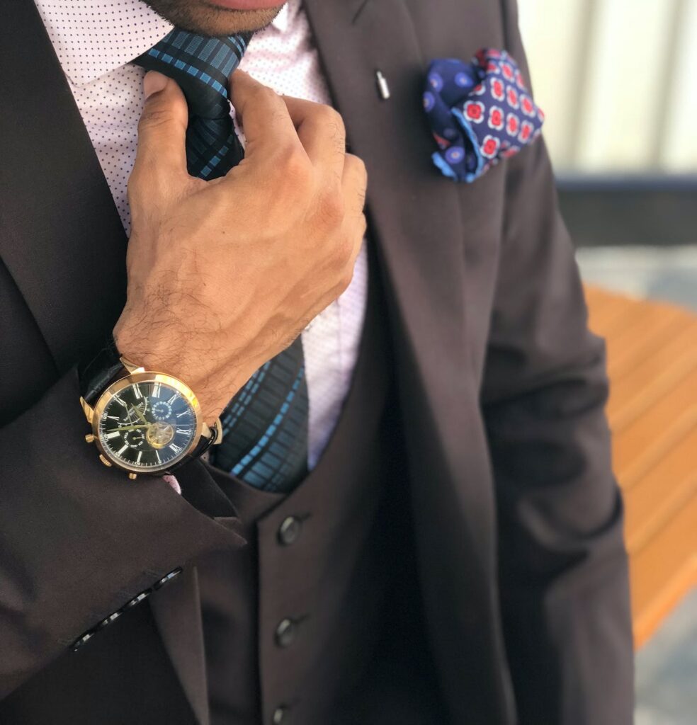 a man with a suit with a mechanical watch