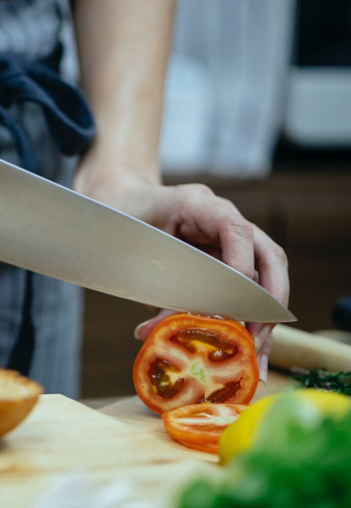 a person cutting tomato