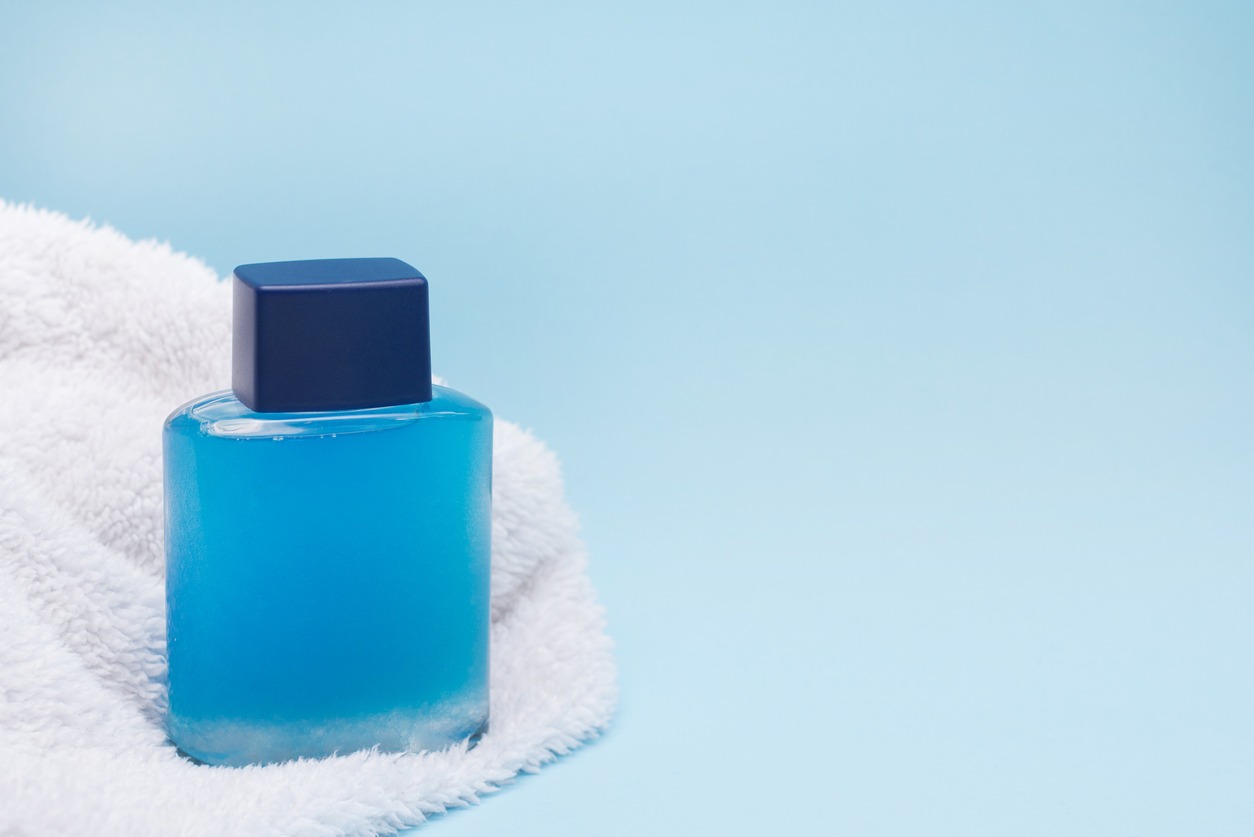 aftershave and a white towel in blue background