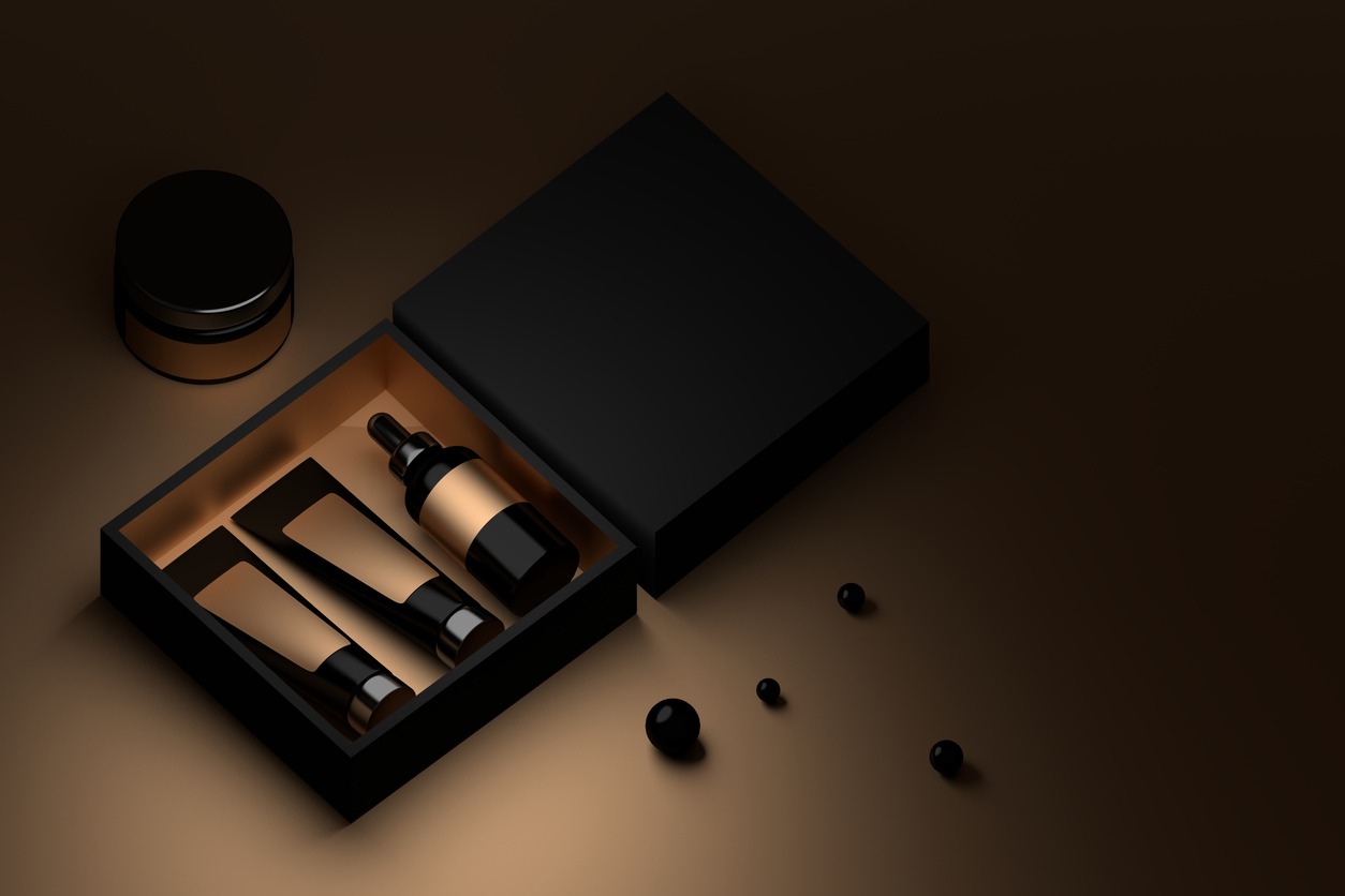 black box with small size refillable bottles and black pearls in brown background