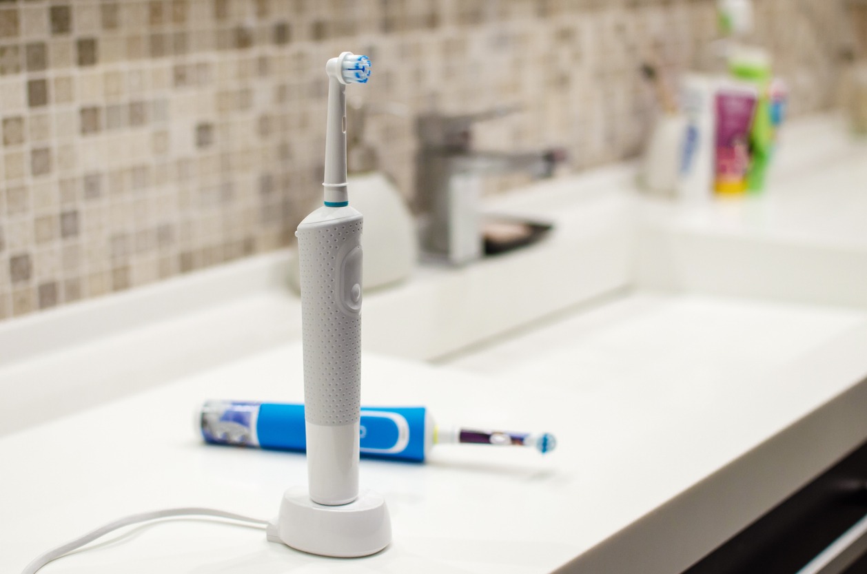 charging electric toothbrush in a bathroom