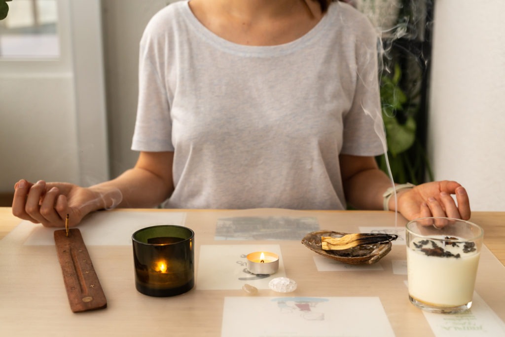 faceless female finding peace at aromatherapy burning aromatic sticks at home
