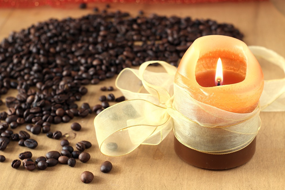 fancy candle with ribbon and coffee beans