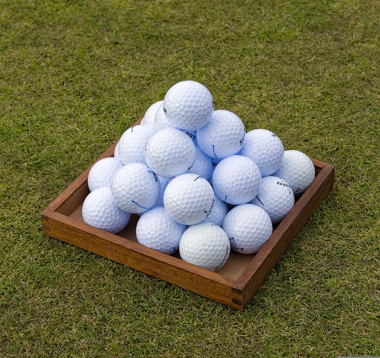 golf balls on box and grass