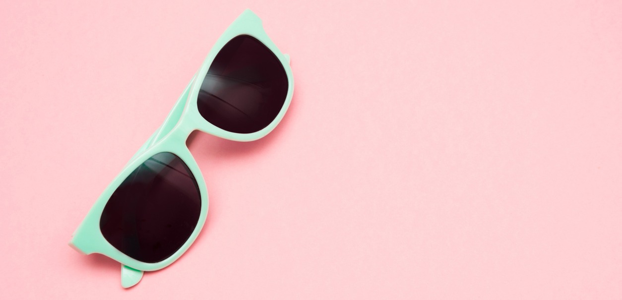 green pastel sunglasses in a pink background