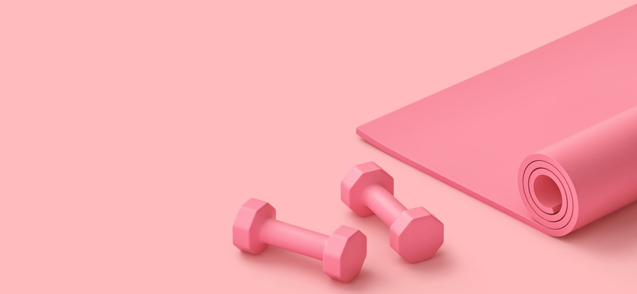pair of pink dumbbells and pink yoga mat on a pink background