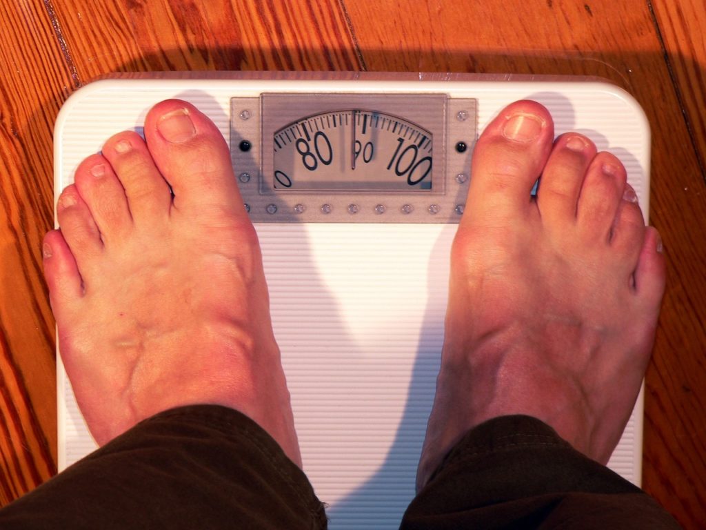 person-stepping-on-a-weight-scale