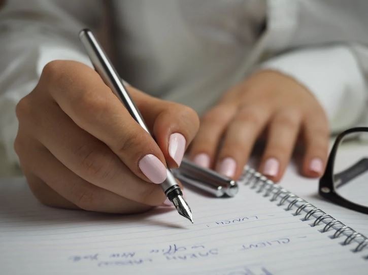 woman writing with fountain pen